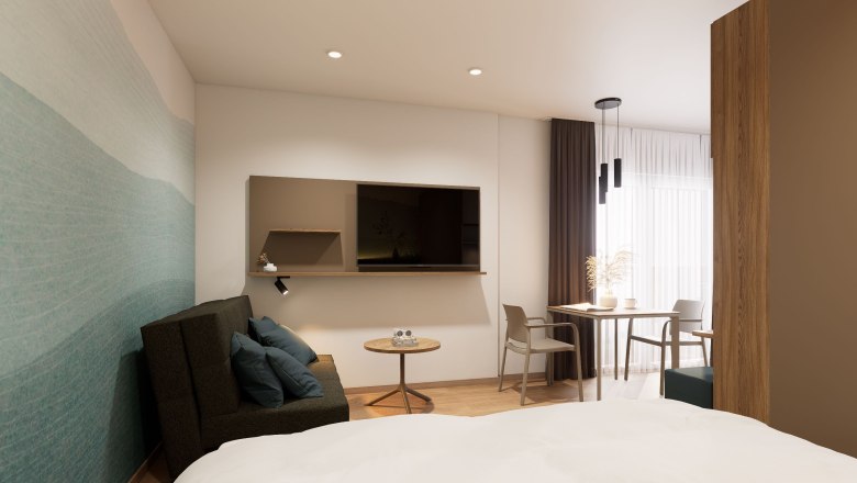 Modern eingerichtetes Apartment mit Sofa, Tisch, St&uuml;hlen und Fernseher.